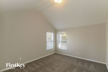 Mcdonough house for rent - the living room of a house with carpet and two windows