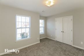Mcdonough house for rent - a bedroom with carpet and a white door and window
