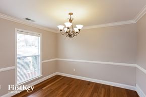 Cordova house for rent - a dining room with a chandelier and a window