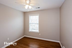 Cordova house for rent - a bedroom with wood floors and a ceiling fan