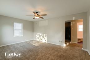 Waukegan house for rent - A spacious room with a ceiling fan and a window.