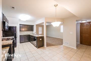 Aurora house for rent - a kitchen and a living room with a stove and a sink