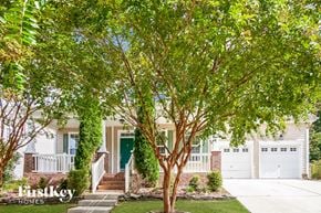 Charlotte house for rent - A tree in front of a house with the text "firstkey homes" on the bottom left.
