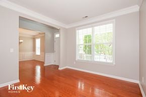 Charlotte house for rent - A room with wooden floors and a window with blinds.