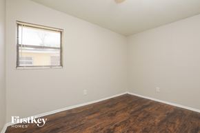 Winter Garden house for rent - a bedroom with wood flooring and a window