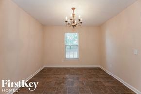 Charlotte house for rent - a empty dining room with tile floors and a chandelier