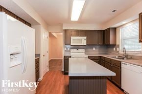 Charlotte house for rent - a kitchen with a white counter top and a refrigerator