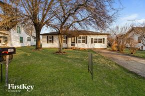 Greenfield house for rent - a white house with a yard and some trees