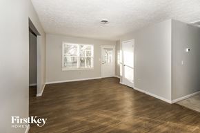 Greenfield house for rent - a living room with a hard wood floor and white walls