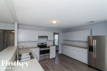 Villa Rica house for rent - a kitchen with white cabinets and stainless steel appliances
