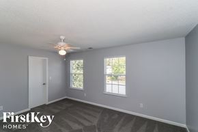 Villa Rica house for rent - a bedroom with a ceiling fan and two windows