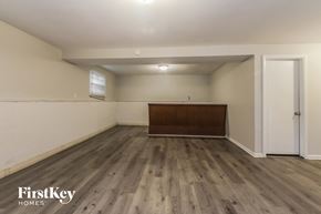 Indianapolis house for rent - the living room of a house with wooden floors and white walls