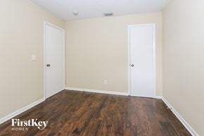 West Palm Beach house for rent - the living room of an apartment with wood flooring and two doors