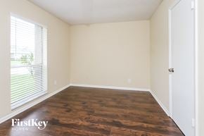 West Palm Beach house for rent - a bedroom with wood flooring and white walls and a window