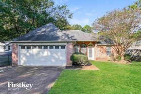 Cordova house for rent - a small brick house with a white garage door