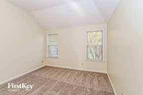 Cordova house for rent - a bedroom with carpet and two windows