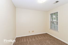 Cordova house for rent - a spacious room with carpet and a window