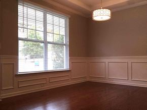 Huntersville house for rent - a dining room with a large window and wood floors