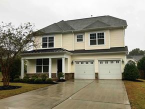 Huntersville house for rent - a house with two garage doors in front of a driveway