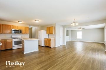 Fishers house for rent - A kitchen with wooden cabinets and a white island.