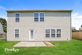 Fishers house for rent - A two-story house with a grey exterior and a white door.