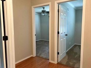Saint Peters house for rent - a bedroom with a closet and a door open to a hallway with a ceiling fan