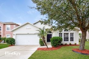 Riverview house for rent - a white house with a garage door and a tree
