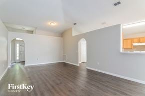 Riverview house for rent - a living room with white walls and a wooden floor