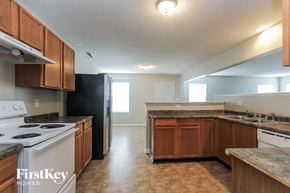 Indianapolis house for rent - a kitchen with white appliances and wooden cabinets