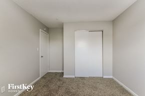 Indianapolis house for rent - a bedroom with a closet and a carpeted floor