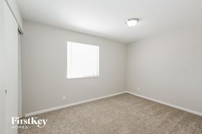 Phoenix house for rent - a spacious room with carpet and a window