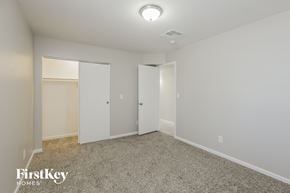 Phoenix house for rent - a bedroom with white walls and carpet and a closet