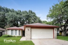 Houston house for rent - a small brick house with a white garage door
