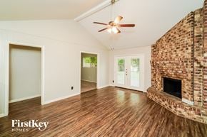 La Porte house for rent - a living room with a fireplace and a ceiling fan