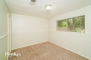 La Porte house for rent - a bedroom with a large window and a carpeted floor