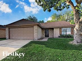 Houston house for rent - a single story home with a garage and a tree