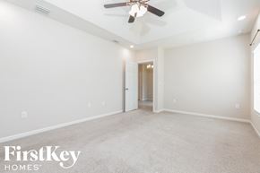 Melbourne house for rent - a empty living room with a ceiling fan and white walls