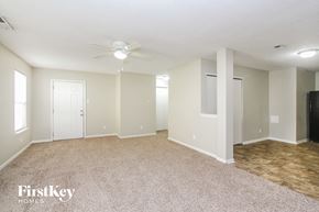 Camby house for rent - A spacious room with a ceiling fan and lighting fixtures.
