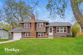 Shawnee house for rent - a brown and with a green lawn and trees