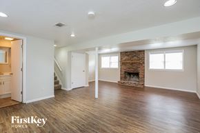 Shawnee house for rent - the living room with wood floors and a fireplace