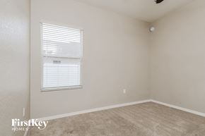 Wimauma house for rent - a bedroom with a window and a carpeted floor