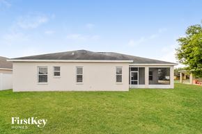 Wimauma house for rent - a white house with a grassy yard and a gray roof