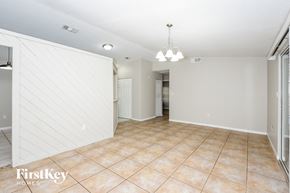 Palm Bay house for rent - an empty living room with a white wall and a tile floor