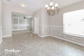 Port St. Lucie house for rent - a dining room with a chandelier and a window