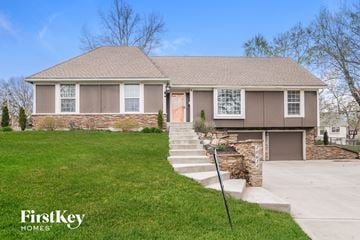 Overland Park house for rent - a home with stairs in front of a lawn