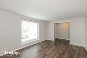 Overland Park house for rent - the living room of a home with wooden floors and a large window