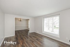 Overland Park house for rent - a living room with a large window and wooden floors