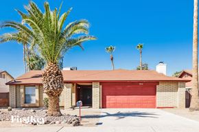 Phoenix house for rent - A house with a red garage door is for sale.