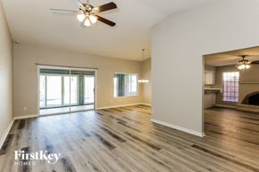 Phoenix house for rent - A spacious room with wooden floors and a ceiling fan.