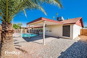 Phoenix house for rent - A house with a pool in the backyard.